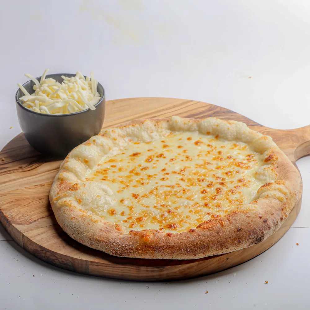 A cheese manakeesh on a wooden board