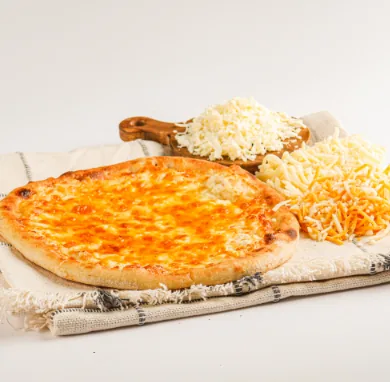 A manakeesh topped with cheese and seeds
